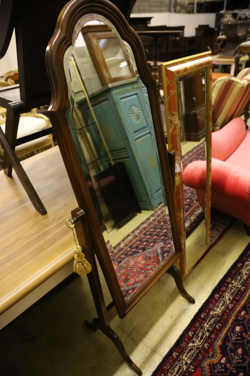 A modern mahogany cheval mirror with shaped top, 160cm high and a rectangular wall mirror with decorative frame